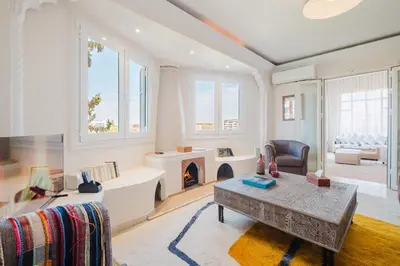 a living room with a table and a fireplace at Confort Spacieux a Hivernage 3 Chambres and Piscine in Marrakech