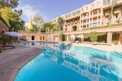 a swimming pool in front of a building at Confort Spacieux a Hivernage 3 Chambres and Piscine in Marrakech