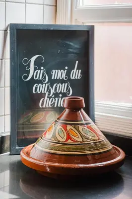 a vase is sitting in front of a sign at Confort Spacieux a Hivernage 3 Chambres and Piscine in Marrakech