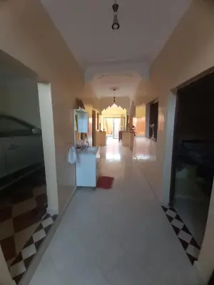 a hallway of a house with a refrigerator in it at Small villa with heated pool & garage for families in Marrakech