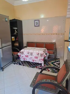 a room with a bed with a table and chairs at Small villa with heated pool & garage for families in Marrakech