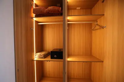 a walk in closet with wooden walls and lights at La villa luxury suites in Marrakech