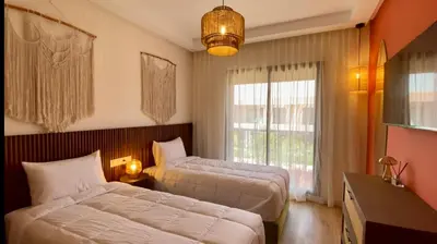 a bedroom with a bed and a window at Alba cosy - 3 piscines, Wifi HD, Parc de jeux in Marrakech