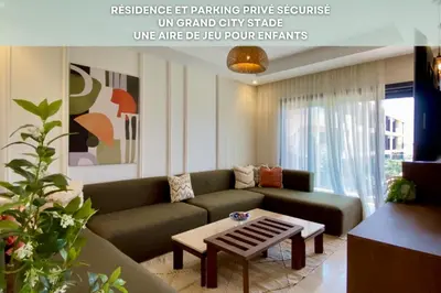 a living room with a couch and a coffee table at Alba cosy - 3 piscines, Wifi HD, Parc de jeux in Marrakech