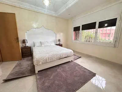a bedroom with a large bed and a window at Élégante Villa 3 Chambres avec Jardin & Piscine Targa Afak Marrakech in Marrakech