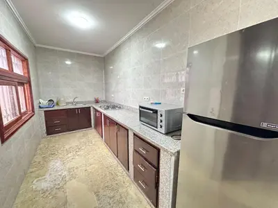 a kitchen with a stainless steel refrigerator and a microwave at Élégante Villa 3 Chambres avec Jardin & Piscine Targa Afak Marrakech in Marrakech