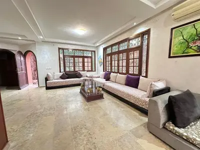 a living room with two couches and a table at Élégante Villa 3 Chambres avec Jardin & Piscine Targa Afak Marrakech in Marrakech
