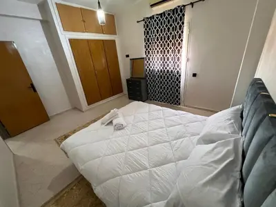 a bedroom with a large white bed in a room at Y&J Stay - Modern and Comfort in Marrakech