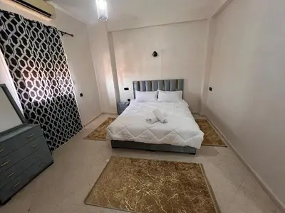 a bedroom with a bed with white sheets and pillows at Y&J Stay - Modern and Comfort in Marrakech