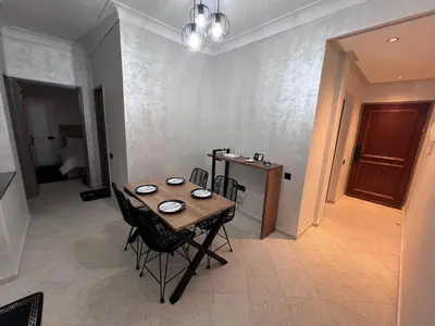 a dining room with a table and chairs in a room at Y&J Stay - Modern and Comfort in Marrakech