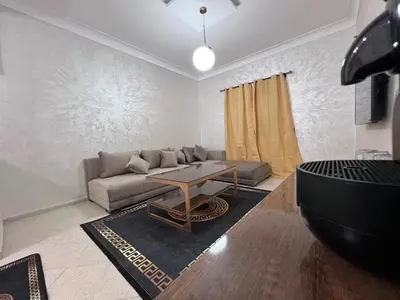 a living room with a couch and a table at Y&J Stay - Modern and Comfort in Marrakech