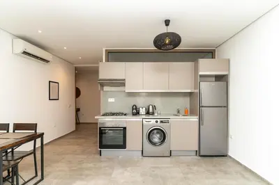 a kitchen with a stove and a dishwasher at Appartement gueliz, hyper centre in Marrakech