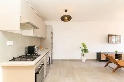 a kitchen with a stove top oven next to a table at Appartement gueliz, hyper centre in Marrakech