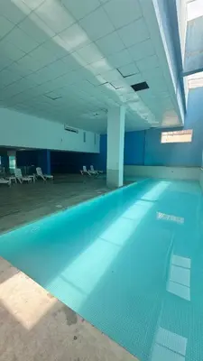 a swimming pool in a building with a blue floor at Appartement gueliz, hyper centre in Marrakech