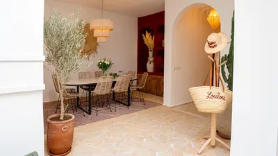 a dining room with a table and chairs at Private Riad Loulou Zitoun - rooftops - 2 pools - 4 rooms in Marrakech