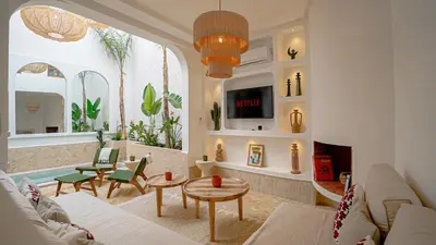 a living room with a couch and a table at Private Riad Loulou Zitoun - rooftops - 2 pools - 4 rooms in Marrakech