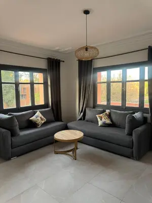 a living room with couches and a table and windows at Golden palm appart in Marrakech
