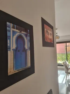 two pictures hanging on a wall in a room at Appartement Gueliz Carré Eden 90m2 idéalement placé in Marrakech