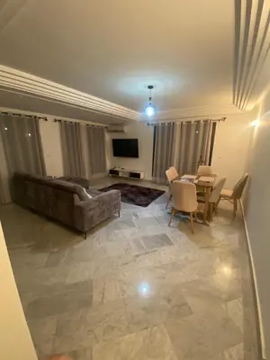 a living room with a couch and a table at Appartement Gueliz Carré Eden 90m2 idéalement placé in Marrakech