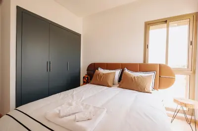 a bedroom with a large bed with two towels on it at Z-series Appartement unique et moderne in Marrakech