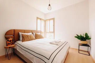 a bedroom with a large bed with a window at Z-series Appartement unique et moderne in Marrakech