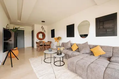 a living room with a couch and a table at Z-series Appartement unique et moderne in Marrakech