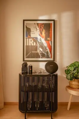 a book shelf with a picture on the wall at Z Series Cozy and Modern Apartment in Marrakech