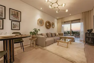 a living room with a couch and a table at Z Series Cozy and Modern Apartment in Marrakech