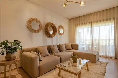a living room with a couch and mirrors on the wall at Z Series Cozy and Modern Apartment in Marrakech