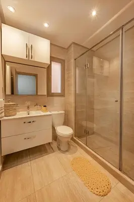 a bathroom with a shower and a toilet and a sink at Z Series Cozy and Modern Apartment in Marrakech