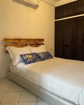 a bed with two pillows on it in a room at Riad butterfly marrakech 2 in Marrakech