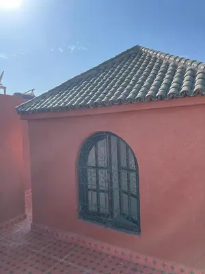 a red building with a window on the side of it at Riad butterfly marrakech 2 in Marrakech