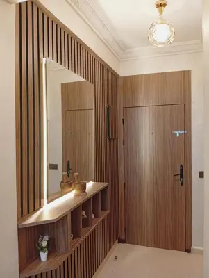a bathroom with a mirror and a wooden door at Airport view apartment Marrakech in Marrakech