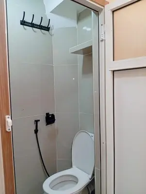 a small bathroom with a toilet and a shower at Airport view apartment Marrakech in Marrakech