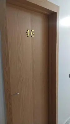 a wooden door with the number on it at Beautiful apartment with children's pool in Marrakech