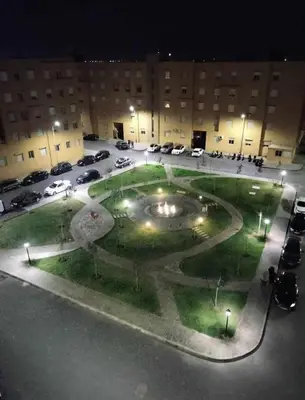 a parking lot with a large fountain in front of a building at Beautiful apartment with children's pool in Marrakech