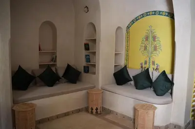 two benches in a room with pillows at Maristan Aicha Marrakech in Marrakech