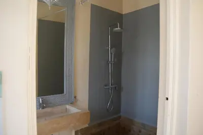 a bathroom with a shower with a sink and a mirror at Maristan Aicha Marrakech in Marrakech