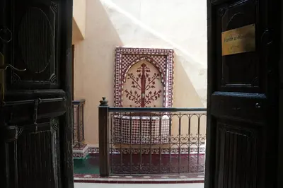 an ornate gate in a hallway of a building at Maristan Aicha Marrakech in Marrakech