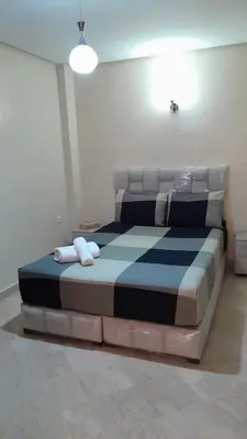 a bedroom with a bed with two towels on it at hébergement in Guéliz in Marrakech