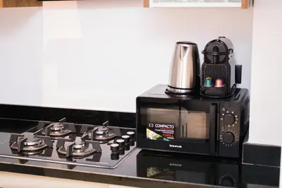 a microwave oven with a coffee pot on top of it at Modern apartment-pool-secure Gueliz in Marrakech