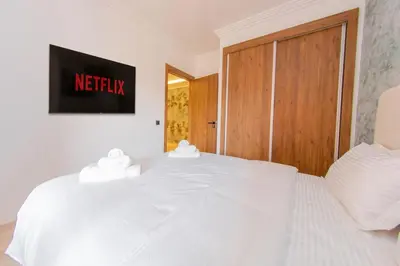 a white bed with two white towels on top of it at Modern apartment-pool-secure Gueliz in Marrakech