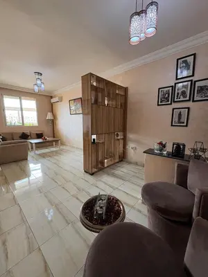 a living room with a couch and a cabinet at Elegant apartment near the airport in Marrakech