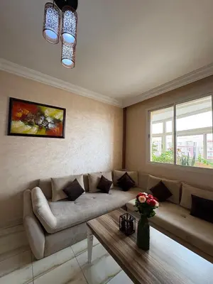 a living room with a couch and a table at Elegant apartment near the airport in Marrakech