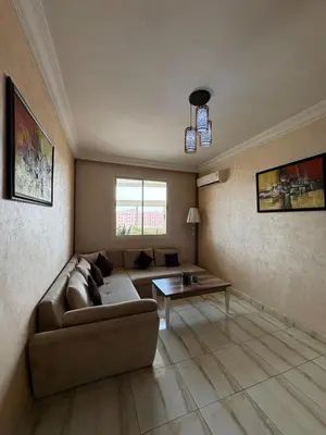 a living room with a couch and a table at Elegant apartment near the airport in Marrakech