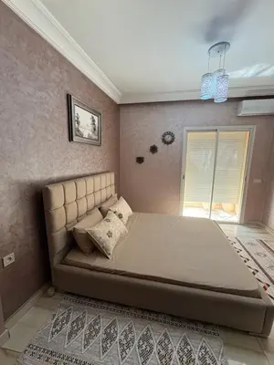 a bedroom with a large bed in a room at Elegant apartment near the airport in Marrakech