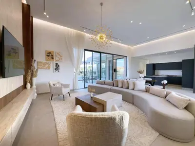 a living room with a large couch and chairs at Villa de Luxe Sans Vis-à-Vis 15 min de Marrakech in Marrakech
