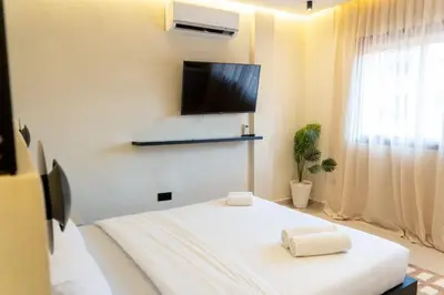 a bedroom with a bed and a flat screen tv at Studio Chic Coeur de Gueliz in Marrakech
