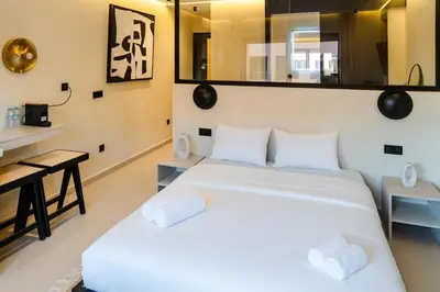 a bedroom with a large white bed and a desk at Studio Chic Coeur de Gueliz in Marrakech