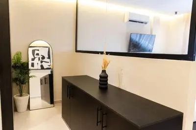 a room with a black table and a mirror at Studio Chic Coeur de Gueliz in Marrakech